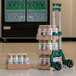 A Harper folding hand truck with a stack of plastic bottles and a cooler on it.