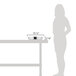 A woman standing next to a table with a Vollrath stainless steel food pan on it.