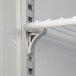 A close up of a white shelf in a Beverage-Air countertop display refrigerator with a metal bracket.