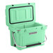 A seafoam green CaterGator outdoor cooler with a handle.