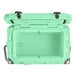 A seafoam green CaterGator outdoor cooler with black handles and a lid.