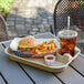 An EcoChoice Pulp Fiber Cup Carrier with a hamburger, fries, and a drink on it.