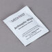 A white Medi-First packet with black text for antiseptic wipes.