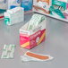 A box of Medi-First woven adhesive bandage strips on a counter.