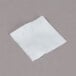 A white square Medi-First alcohol prep pad on a gray surface.