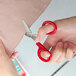 A person cutting fabric with Medi-First angled first aid scissors.