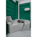 A PolyJohn portable restroom with green walls and a green seat.
