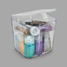 A clear Deflecto stackable caddy container filled with various colors of glitter.