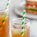 Two glasses of iced tea with EcoChoice green and white striped paper straws.