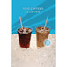 A Cornelius Quest Elite cold beverage dispenser with iced coffee and lattes in plastic cups on ice.