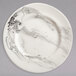 A white porcelain plate with black and white marbled designs.