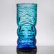 A close up of a blue OG Tiki glass with a face on it.