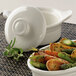 A white Libbey porcelain casserole dish with carrots and asparagus in it.