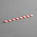 An EcoChoice red and white striped paper straw.