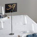 A table set with a Choice Chrome Menu Holder with a number on it.