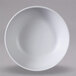 A white Elite Global Solutions Kona round coupe bowl with specks on a gray background.