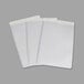 A white object with three C-Line clear self-adhesive shop ticket holders on white paper.