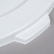 A close up of a white Continental Huskee recycling trash can lid with a hole.