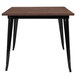 A Flash Furniture table with black metal legs and a brown square wooden top.