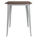 A Flash Furniture bar height table with a wood top and silver metal frame.