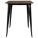 A Flash Furniture bar height table with a black metal frame and wood top.