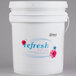 A white bucket with a label reading "Noble Chemical Refresh Concentrated Deodorizing Fluid"