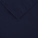 A folded navy blue square table cover with a hemmed edge.