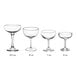 A row of clear Acopa Deco coupe wine glasses with stems.