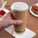 A person holding an EcoChoice paper hot cup with a coffee cup on top.