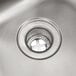 A close-up of a stainless steel Eagle Group hand sink with a drain.