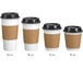 A group of white Choice paper coffee cups with lids and brown sleeves.