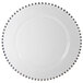 A 10 Strawberry Street white glass charger plate with silver beaded rim.