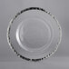 A clear glass charger plate with a silver rim.