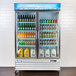 An Avantco white right hinged refrigerator door with glass panel displaying drinks and beverages.