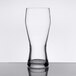 A Libbey customizable pilsner glass on a table with a white background.