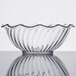 A clear glass tulip bowl with a wavy edge.