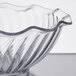 A clear glass tulip bowl with a wavy edge.