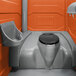 A PolyJohn orange portable restroom with sink, soap, and towel dispenser.