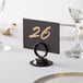A black Choice table card holder with a table number in it.