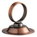 An antique bronze table card holder with a metal ring on a weighted base.