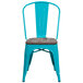 A turquoise metal restaurant chair with a wood seat.