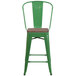 A green metal chair with a wooden seat.