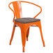 An orange Flash Furniture metal restaurant chair with a wooden seat and arms.