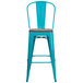 A teal-blue metal bar height stool with a wood seat.