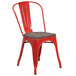 A red metal Flash Furniture restaurant chair with a wooden seat.