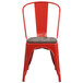 A red metal Flash Furniture restaurant chair with a wooden seat.