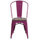 A purple metal chair with a wood seat.