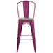 A purple metal bar stool with a wooden seat.