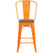 An orange metal Flash Furniture restaurant bar stool with a wooden seat and vertical slat back.