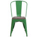 A Flash Furniture green metal chair with a wood seat.